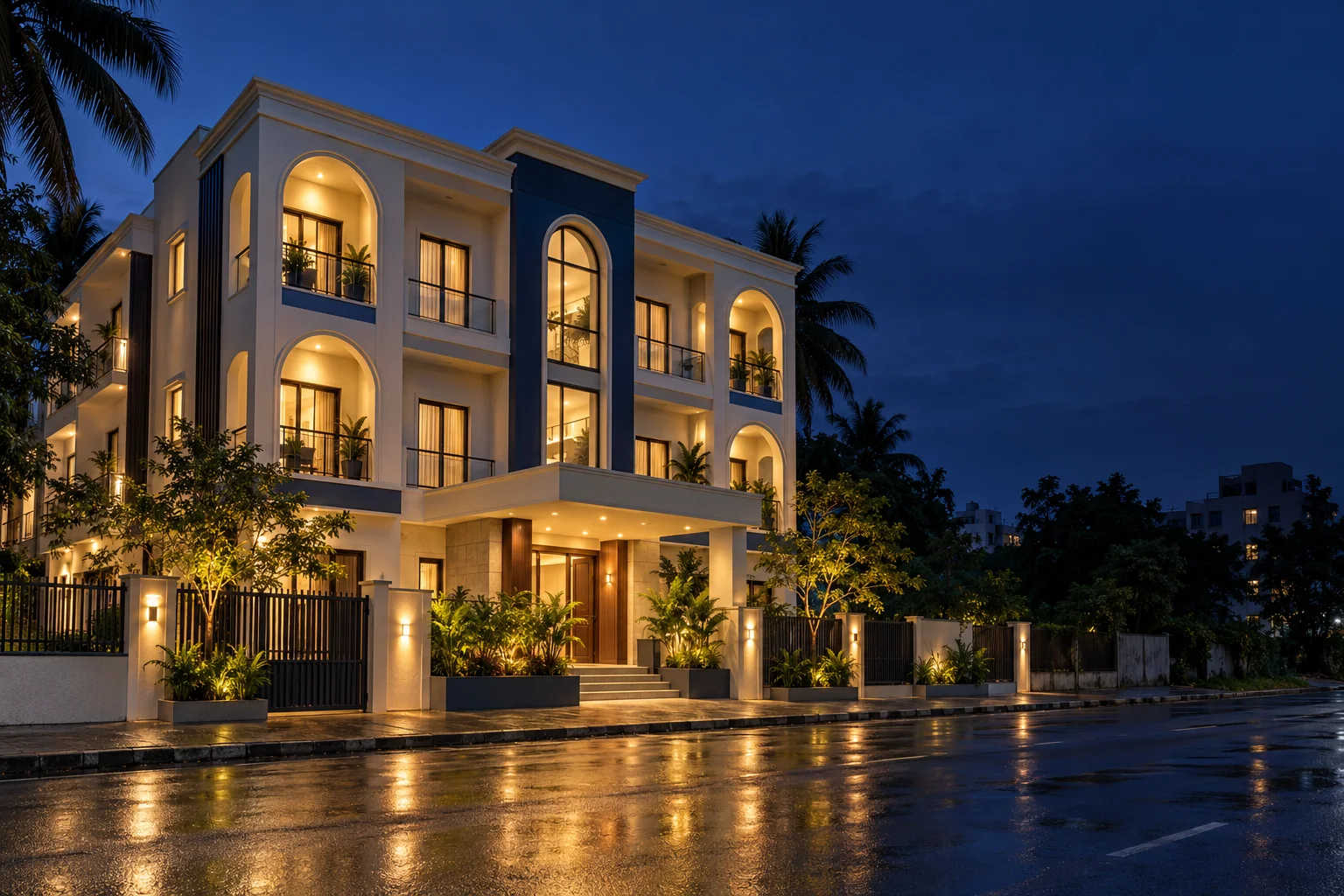 A residential building on a quiet street at dusk with warmly lit windows